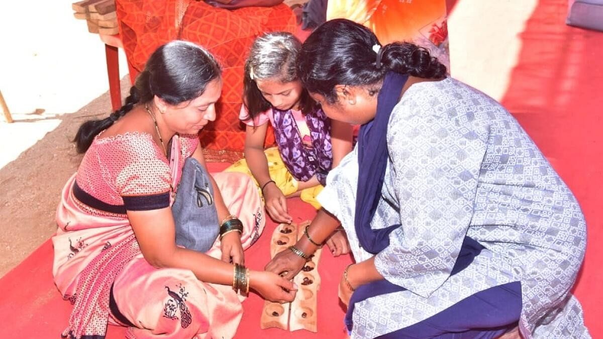 <div class="paragraphs"><p>‘Aliguli mane’ being played at a village fair.</p></div>